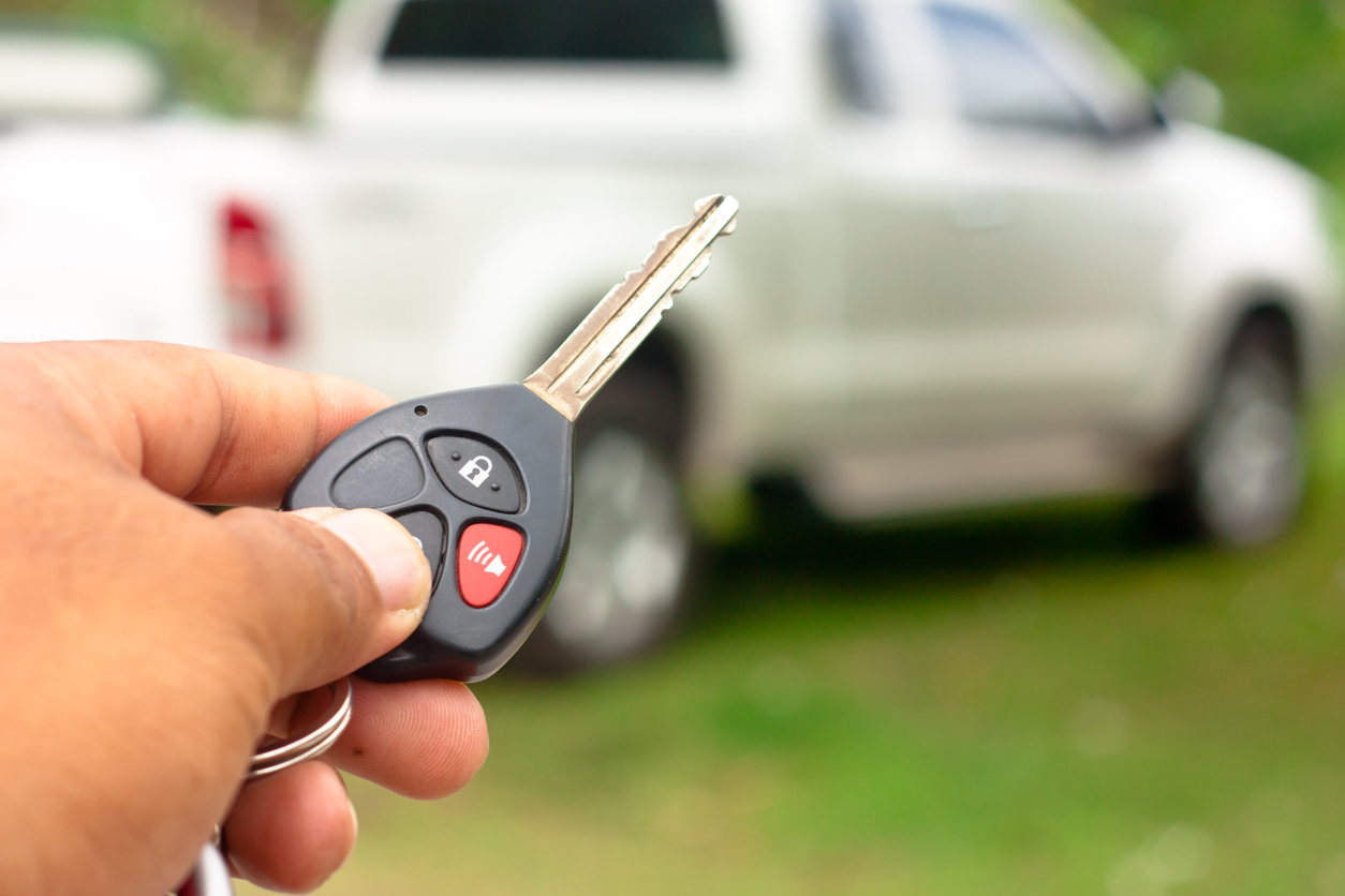Close up Hand holding car key Close up Hand holding car key